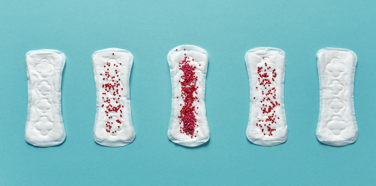 5 menstrual pads with red beads on it in a turquoise background